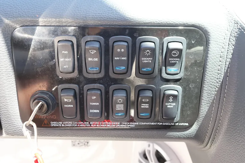 Slide: The Image of Control panel of a 2020 Regal LX4 boat with various switches and ignition key. - 25