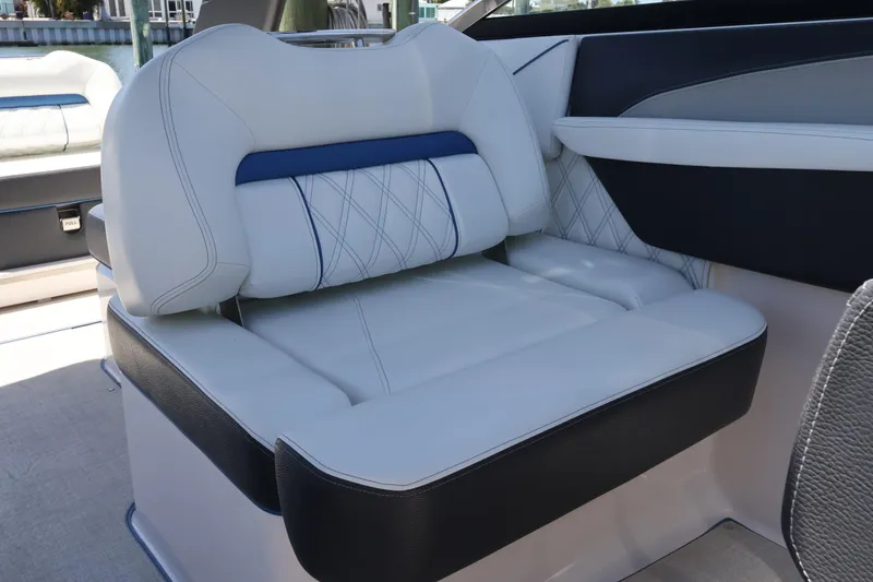Slide: The Image of Luxurious seating on a 2020 Regal LX4 boat, featuring elegant white and blue upholstery. - 27