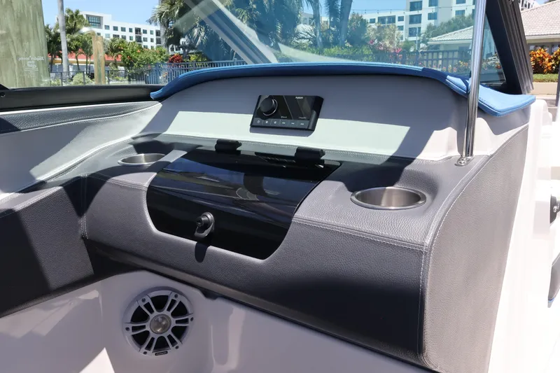 Slide: The Image of 2020 Regal LX4 boat dashboard with cup holders and speaker, featuring modern design elements. - 28
