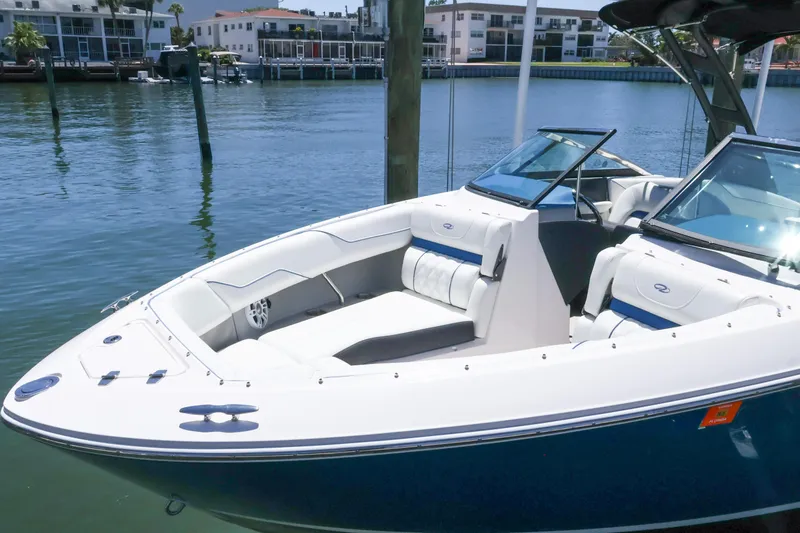 Slide: The Image of 2020 Regal LX4 boat docked in a marina with modern seating. - 30
