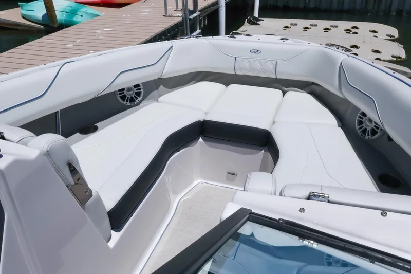 Slide: The Image of Luxurious seating area on a 2020 Regal LX4 boat, docked by the water. - 32