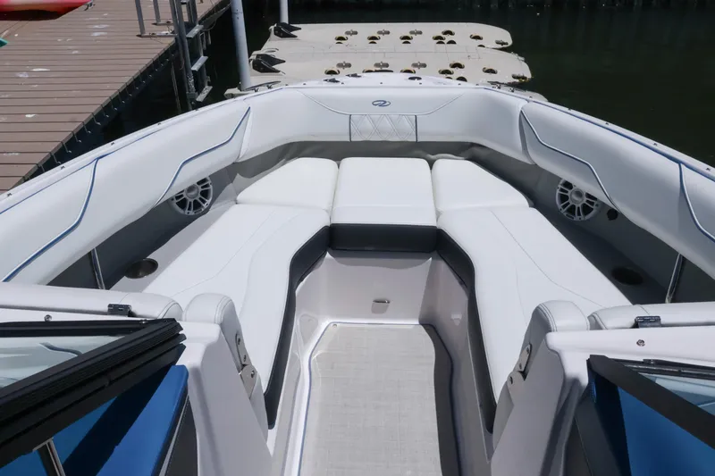 Slide: The Image of 2020 Regal LX4 boat interior with white seating and modern design at a dock. - 33