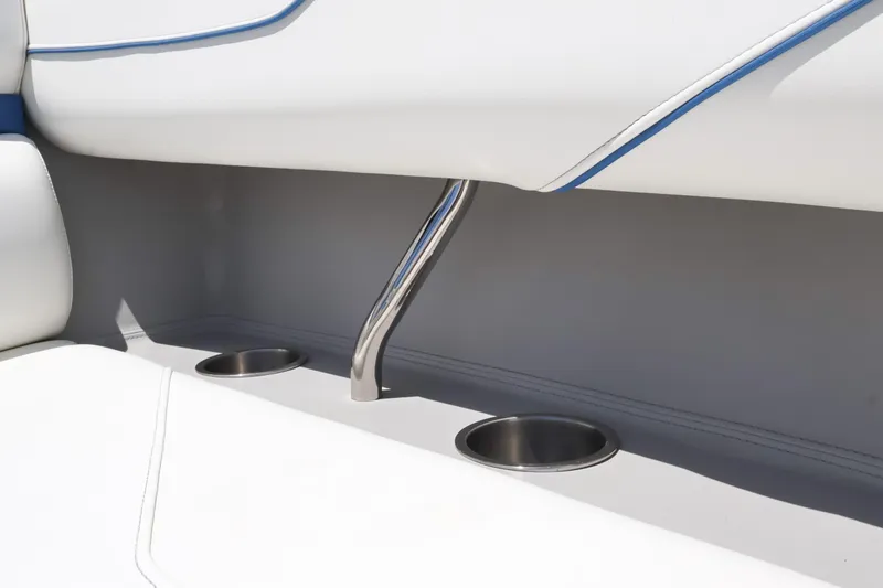 Slide: The Image of 2020 Regal LX4 boat interior with stainless steel cup holders and white seating. - 37