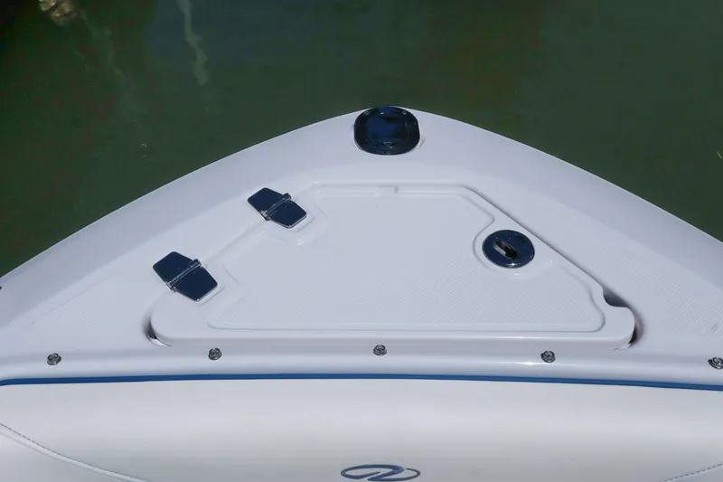 Slide: The Image of Bow of 2020 Regal LX4 boat with storage compartment and hinges. - 38