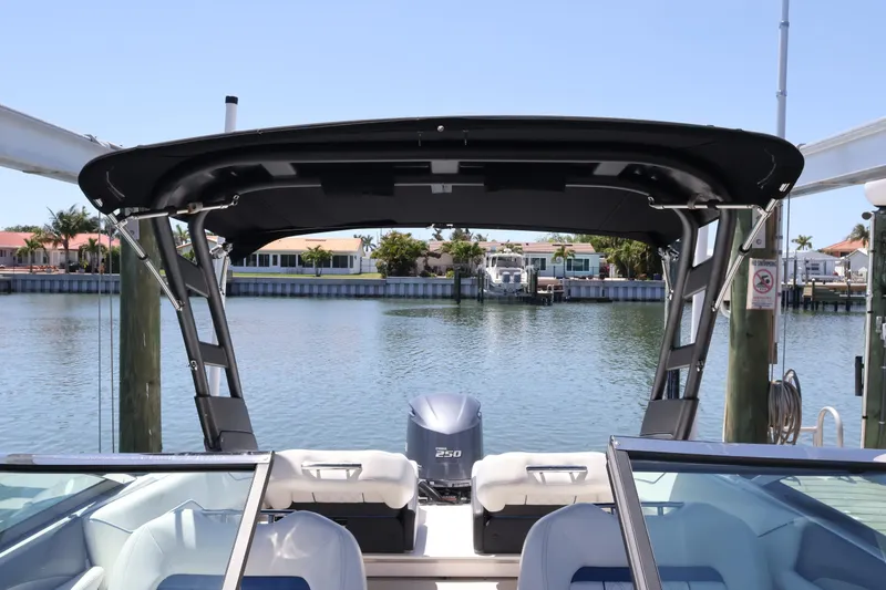 Slide: The Image of 2020 Regal LX4 boat docked by waterfront homes, featuring a sleek design and powerful engine. - 40
