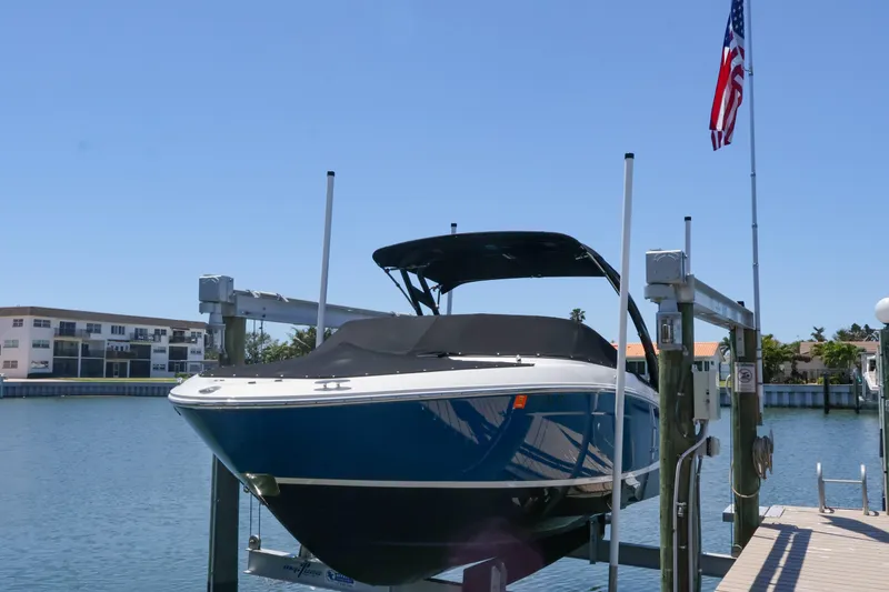 Slide: The Image of 2020 Regal LX4 boat docked on lift with American flag in background. - 5
