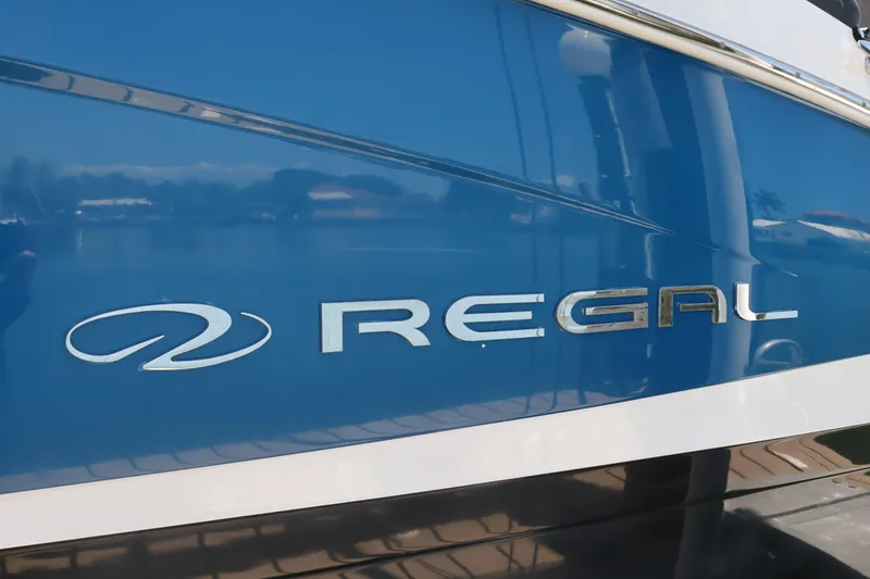 Slide: The Image of 2020 Regal LX4 boat with blue and white exterior detailing. - 7
