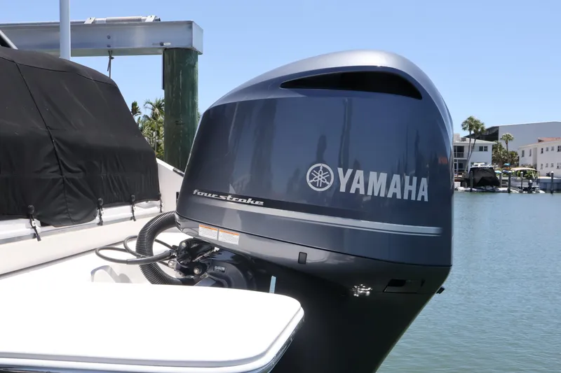 Slide: The Image of Yamaha four-stroke outboard motor on a 2020 Regal LX4 boat docked by the water. - 8