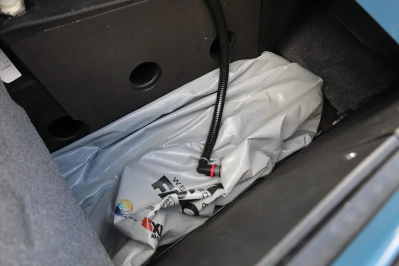 Slide: The Image of 2023 Malibu Wakesetter 22 LSV ballast system with hose and storage compartment. - 14