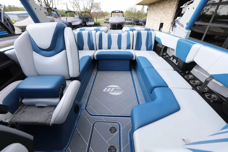 Slide: The Image of 2023 Malibu Wakesetter 22 LSV interior with blue and white seating, showcasing luxury design. - 15