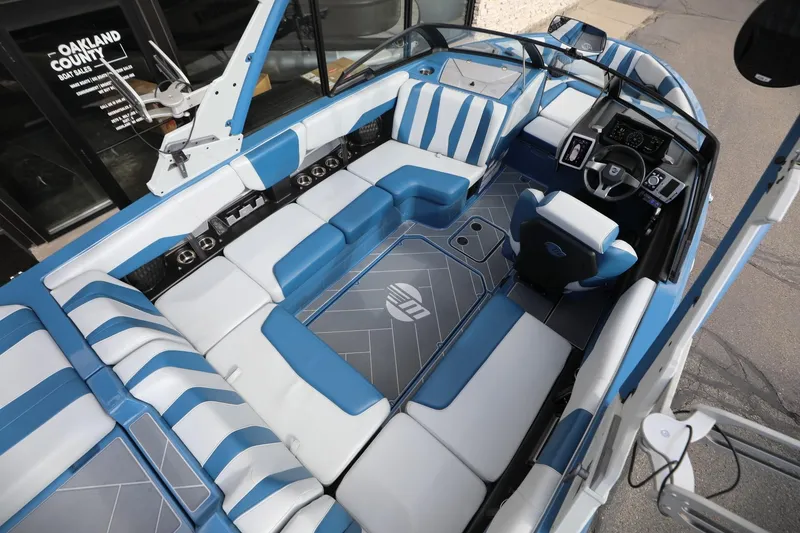 Slide: The Image of 2023 Malibu Wakesetter 22 LSV interior with blue and white seating, modern dashboard. - 18