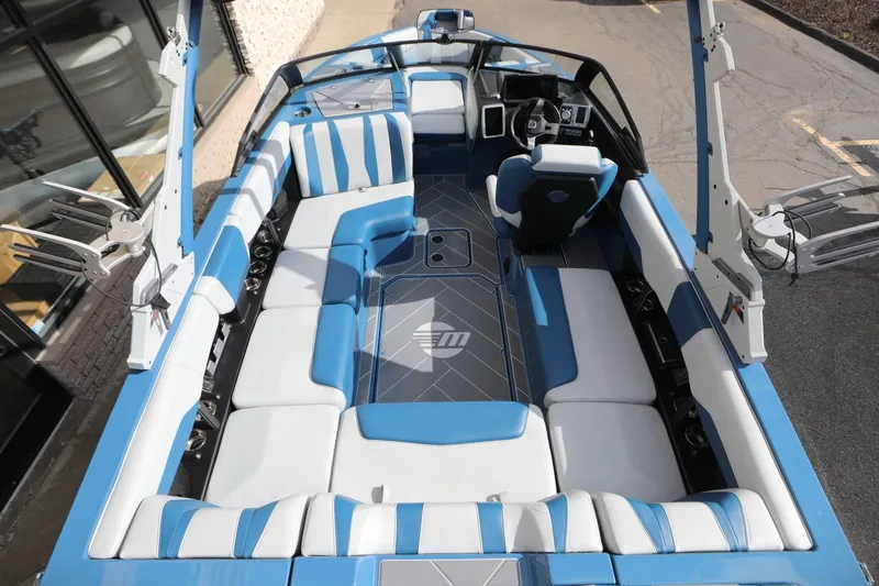 Slide: The Image of 2023 Malibu Wakesetter 22 LSV boat interior with blue and white seating. - 19