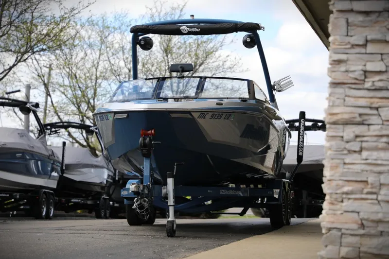 Slide: The Image of 2023 Malibu Wakesetter 22 LSV boat on trailer, parked outdoors. - 22
