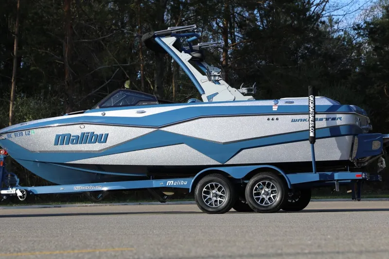 Slide: The Image of 2023 Malibu Wakesetter 22 LSV boat on trailer, parked outdoors. - 23