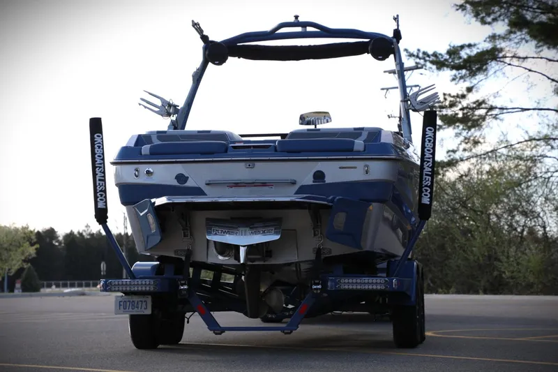 Slide: The Image of 2023 Malibu Wakesetter 22 LSV boat on trailer, rear view, parked outdoors. - 24