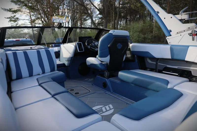Slide: The Image of 2023 Malibu Wakesetter 22 LSV interior with blue and white seating, modern dashboard. - 27