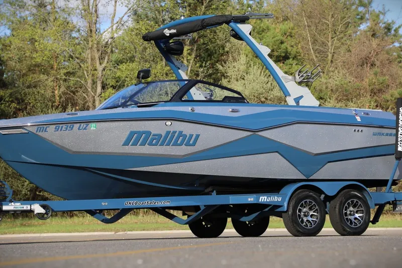 Slide: The Image of 2023 Malibu Wakesetter 22 LSV boat on trailer, parked outdoors. - 28