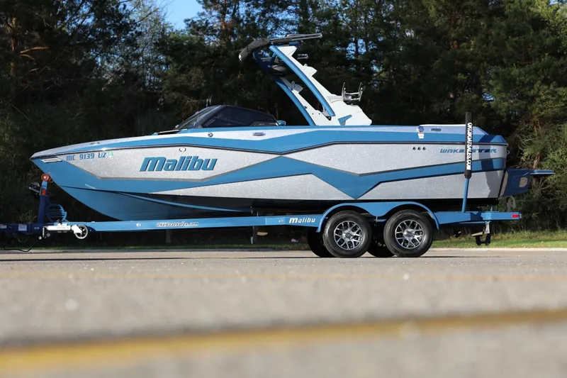 Slide: The Image of 2023 Malibu Wakesetter 22 LSV boat on trailer, parked outdoors. - 30
