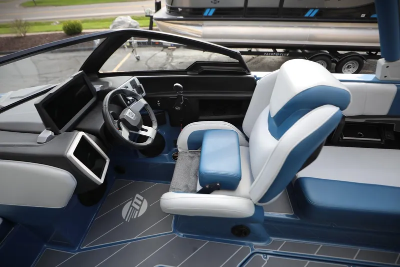 Slide: The Image of 2023 Malibu Wakesetter 22 LSV interior with blue and white seating and modern dashboard. - 5