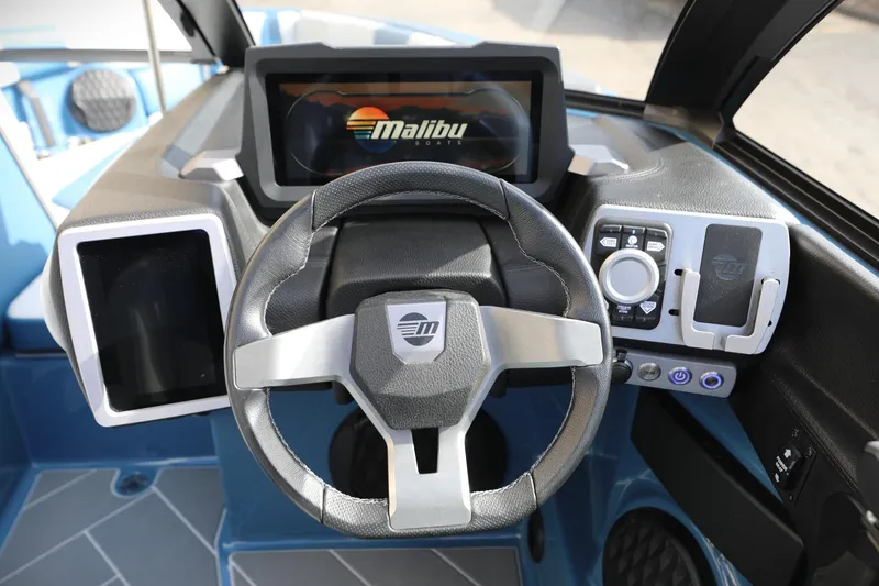 Slide: The Image of 2023 Malibu Wakesetter 22 LSV dashboard with steering wheel and digital display. - 7