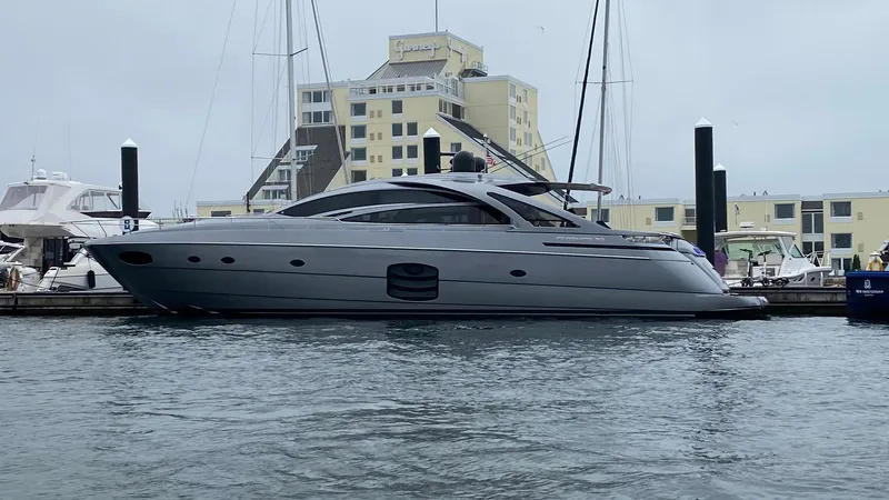 The Image of 2016 Pershing 70 yacht docked at marina with modern architecture in background. - 0
