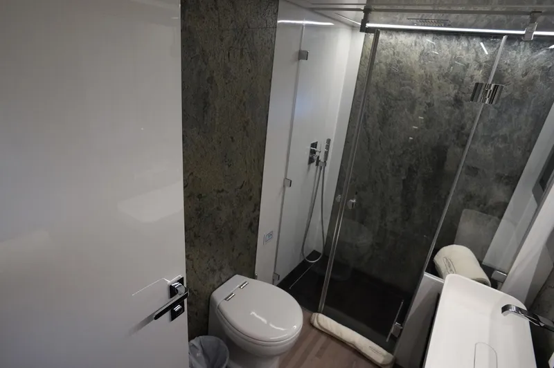 Slide: The Image of Luxurious bathroom in a 2016 Pershing 70 yacht with modern fixtures and glass shower. - 13