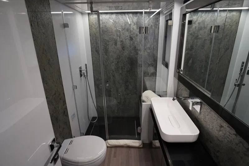 Slide: The Image of Luxurious bathroom in 2016 Pershing 70 yacht with modern fixtures and glass shower. - 14