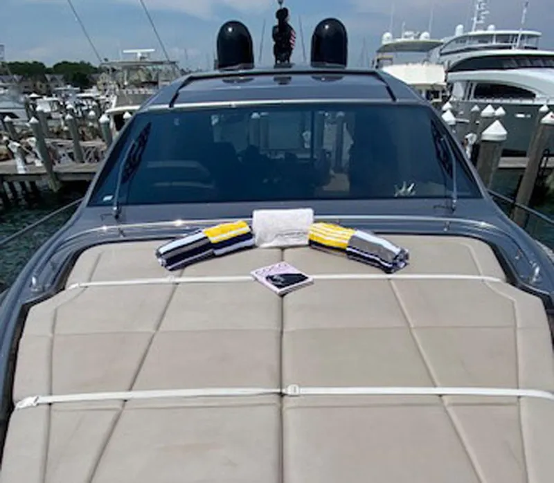 Slide: The Image of 2016 Pershing 70 yacht with sunbathing deck and towels, docked at marina. - 28