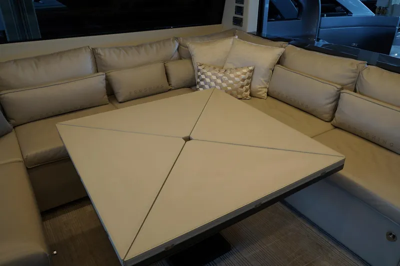 Slide: The Image of Luxurious interior of 2016 Pershing 70 yacht with beige seating and modern table design. - 4