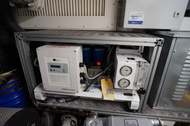 Slide: The Image of Engine room equipment in a 2016 Pershing 70 yacht, featuring control panels and gauges. - 40