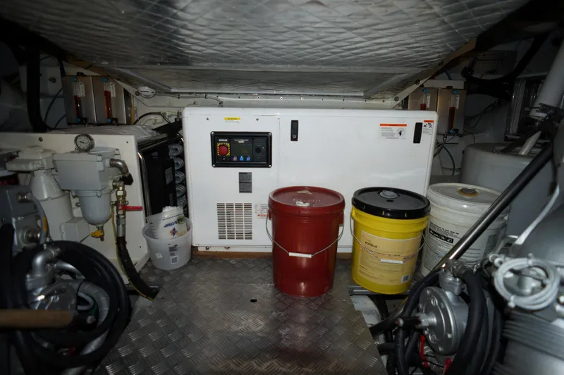 Slide: The Image of Engine room of a 2016 Pershing 70 yacht with equipment and storage barrels. - 43