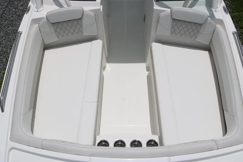 Slide: The Image of 2026 World Cat 230 SD boat interior with white cushioned seating and cup holders. - 4