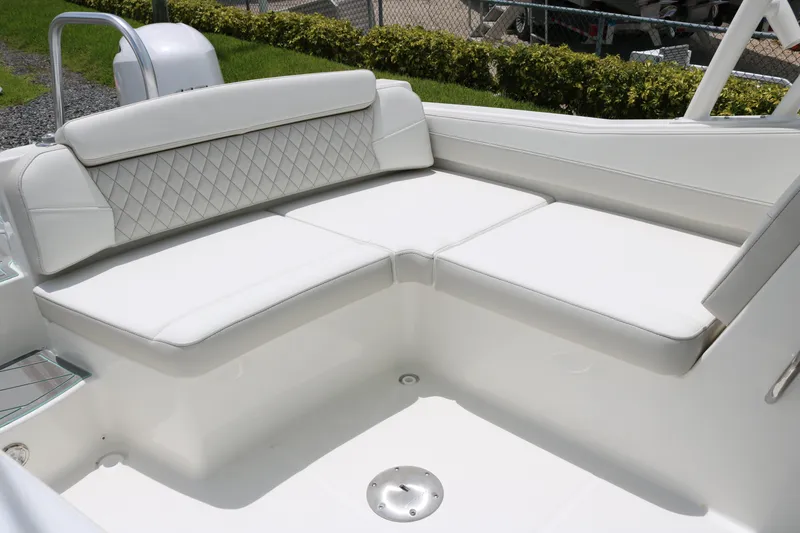 Slide: The Image of Luxurious seating on 2026 World Cat 230 SD boat, featuring white cushioned upholstery. - 12