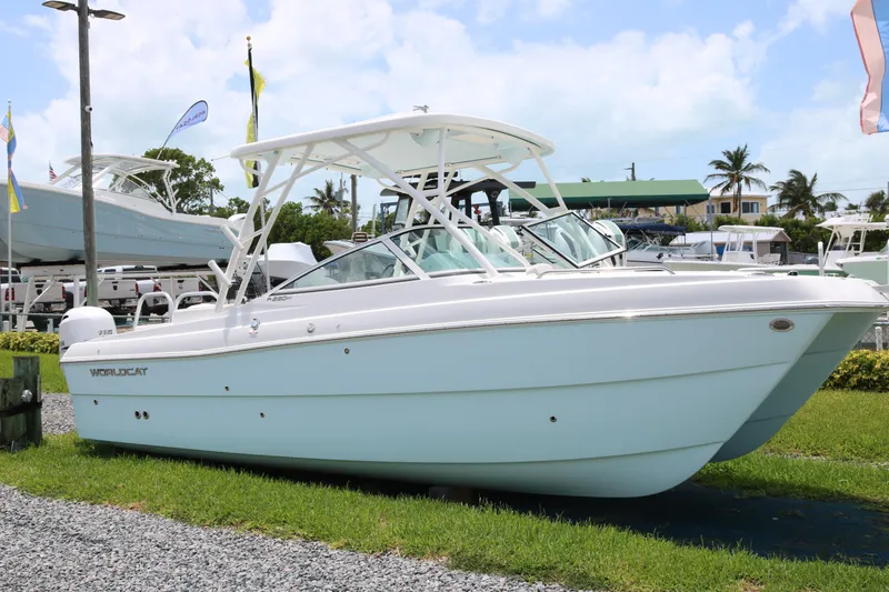 Slide: The Image of 2026 World Cat 230 SD boat displayed outdoors on grass with clear sky background. - 1