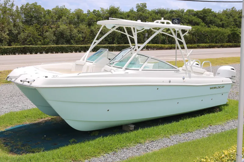 The Image of 2026 World Cat 230 SD boat displayed on grass near a road. - 0