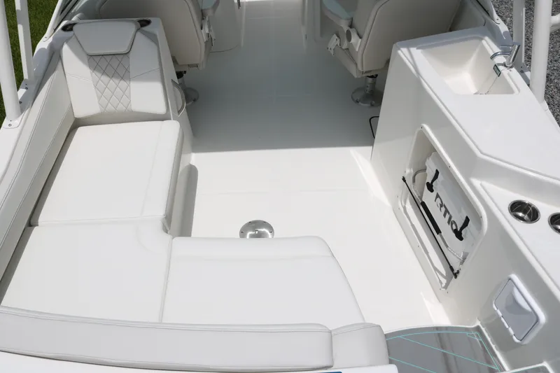 Slide: The Image of Interior view of 2026 World Cat 230 SD boat, featuring white seating and a compact sink area. - 11