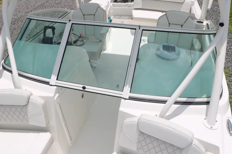 Slide: The Image of 2026 World Cat 230 SD boat interior with white seating and windshield. - 6
