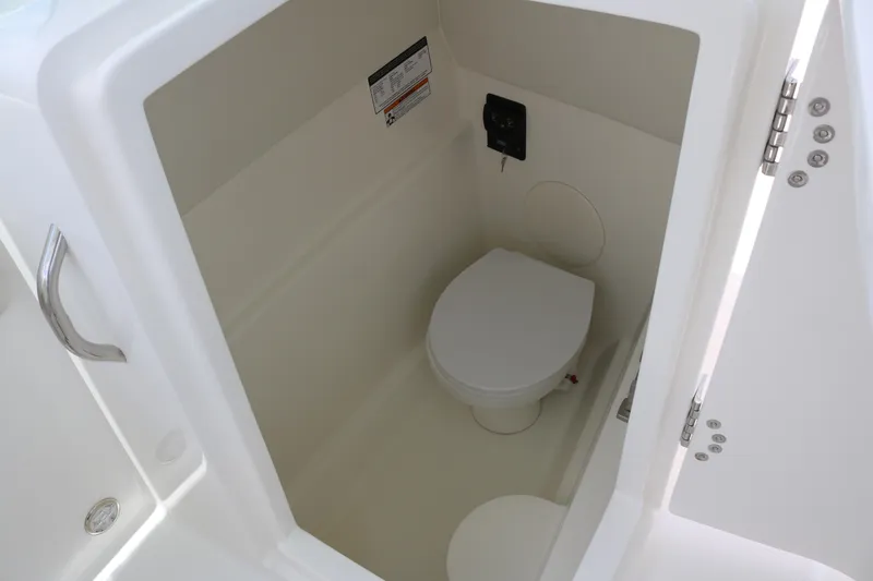 Slide: The Image of 2026 World Cat 230 SD boat interior with compact marine toilet. - 10