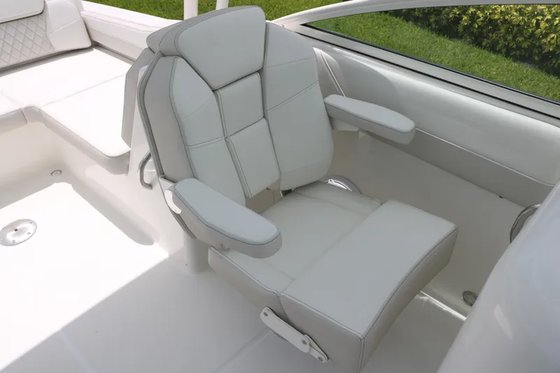 Slide: The Image of Luxury seating on 2026 World Cat 230 SD boat, featuring plush white upholstery. - 9
