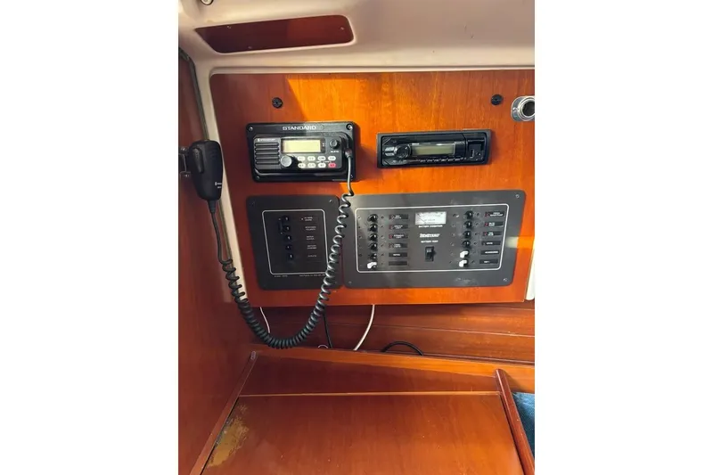 Slide: The Image of Control panel of a 1995 Beneteau Oceanis 321 sailboat with radio and switches. - 19