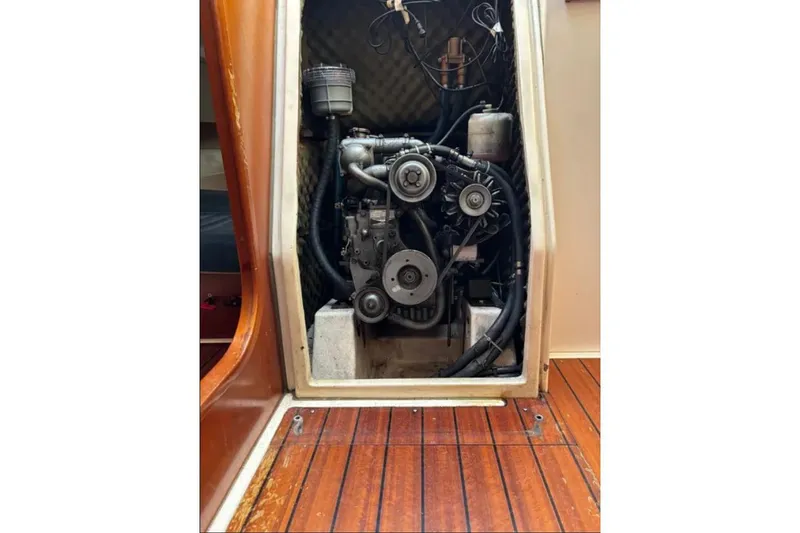 Slide: The Image of Engine compartment of a 1995 Beneteau Oceanis 321 sailboat, showcasing mechanical components. - 20