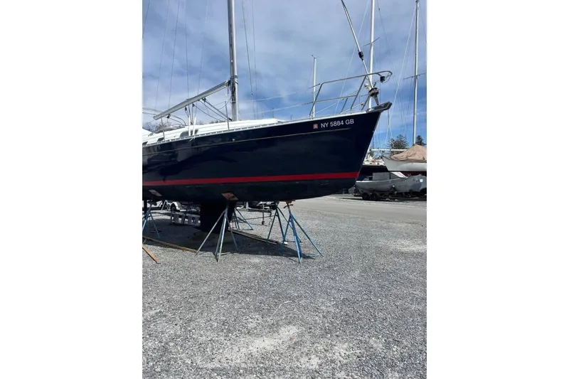 Slide: The Image of 1995 Beneteau Oceanis 321 sailboat on stands in a boatyard. - 3