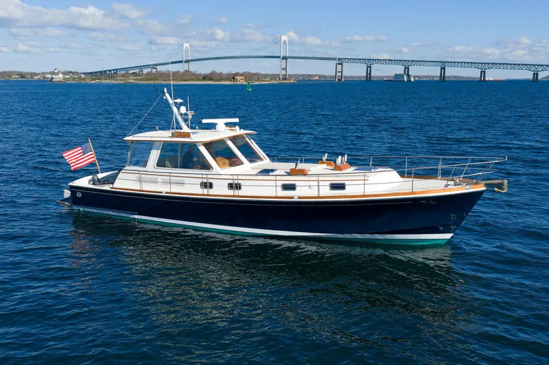 The Image of Eastbay 49 yacht from 2000 cruising near a bridge on a sunny day. - 0