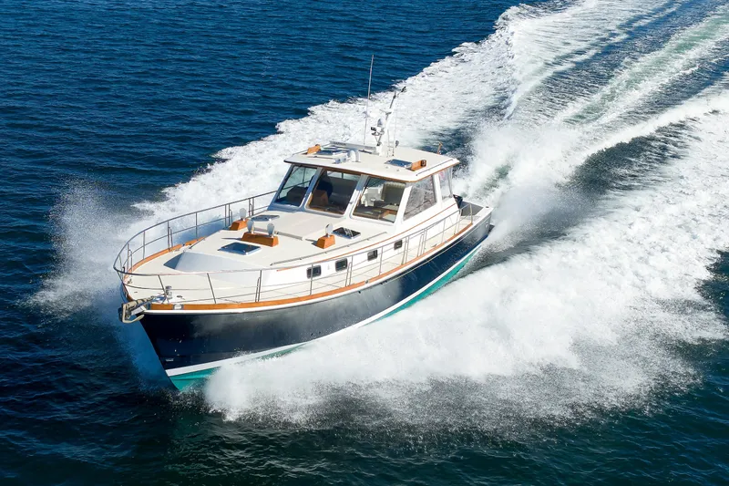 Slide: The Image of Eastbay 49 yacht cruising on open water, 2000 model, creating a dynamic wake. - 1