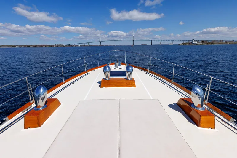 Slide: The Image of Bow view of 2000 Eastbay 49 yacht on open water with bridge in background. - 10