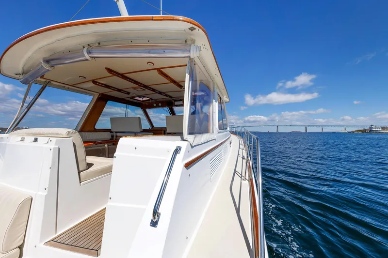 Slide: The Image of Luxurious 2000 Eastbay 49 yacht cruising on open water under a clear blue sky. - 11