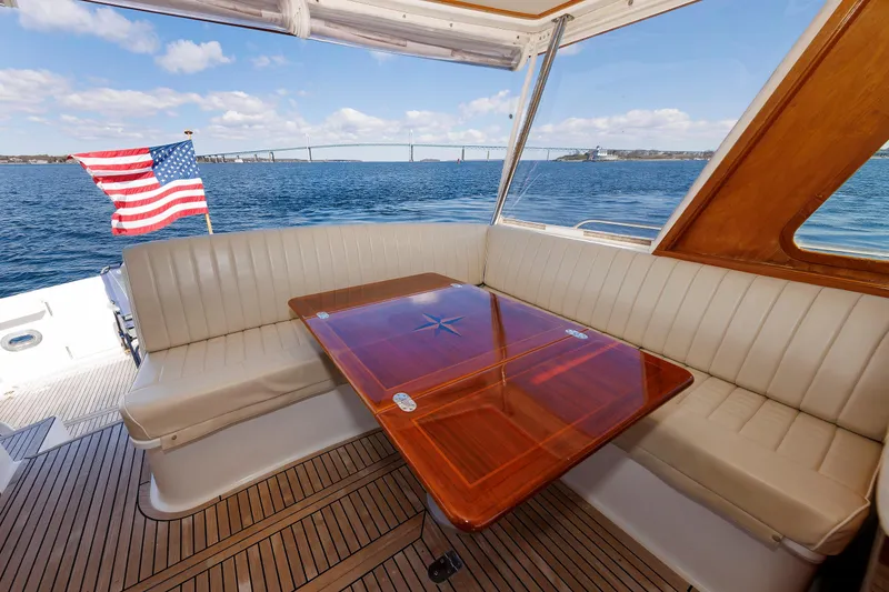 Slide: The Image of Luxurious seating area on a 2000 Eastbay 49 yacht with ocean view and American flag. - 17