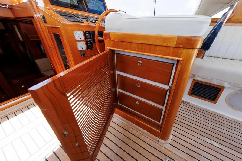 Slide: The Image of Luxurious Eastbay 49 yacht interior with wooden cabinetry and navigation controls, year 2000 model. - 19