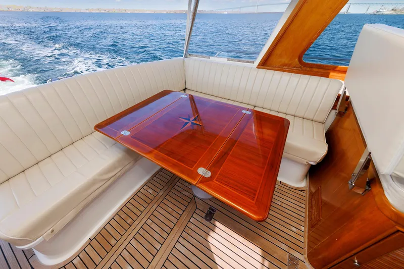 Slide: The Image of Luxurious Eastbay 49 yacht interior with elegant wood table and white seating, 2000 model. - 21
