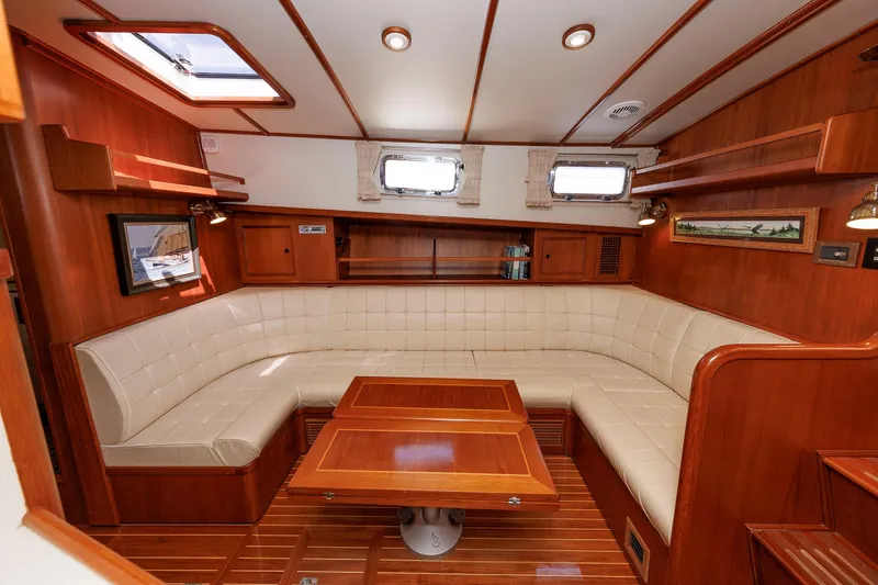 Slide: The Image of Luxurious interior of a 2000 Eastbay 49 yacht with plush seating and wooden accents. - 28